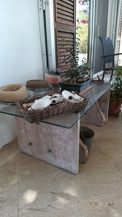 Mesa exterior rústica de pedra e vidro