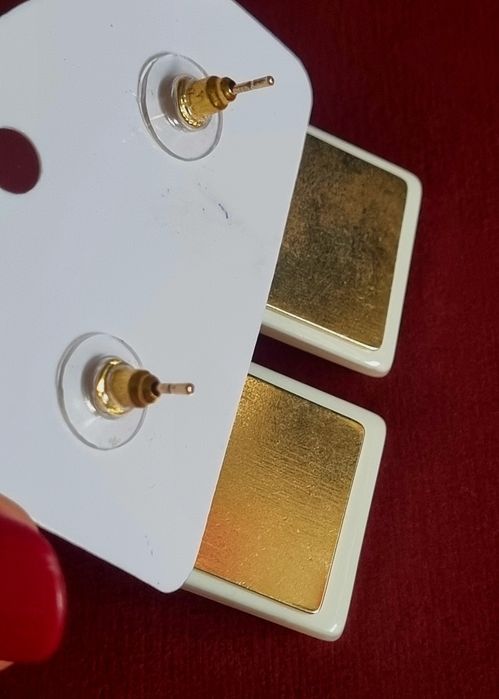 Brincos dourados, com 2 quadrados em acrílico unidos. De pico.