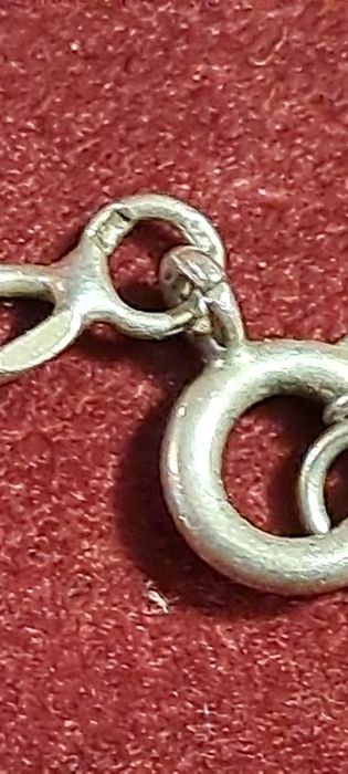 Fio corrente com cruz em prata contrastada.