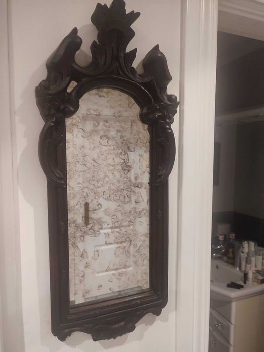 Aged mirror with brown frame.514452556119418887