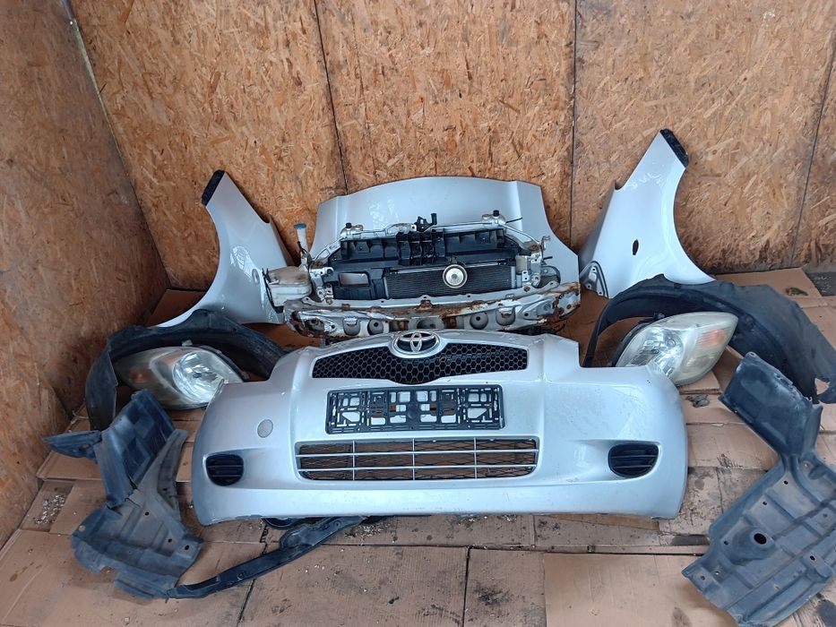 Toyota Yaris II maska zderzak błotnik lampa  reflektor nadkole pas przedni wzmocnienie czołowe chłodnice chlodnica klimatyzacji cieczy benzyna KPL