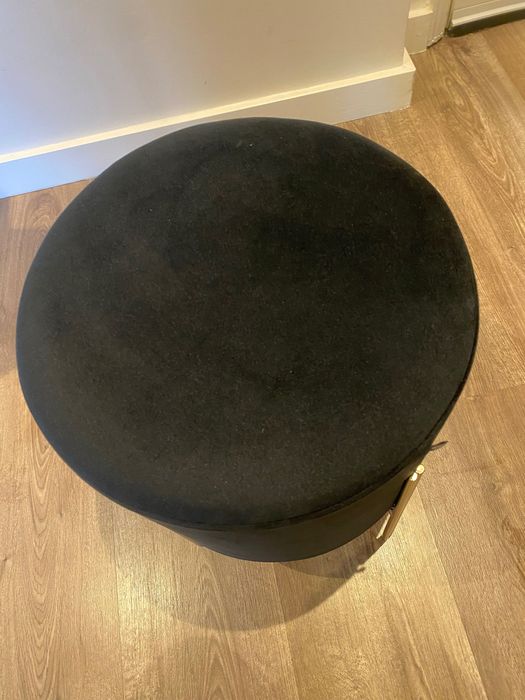 Puff preto com pernas em metal dourado, dimensões 40x34 cm