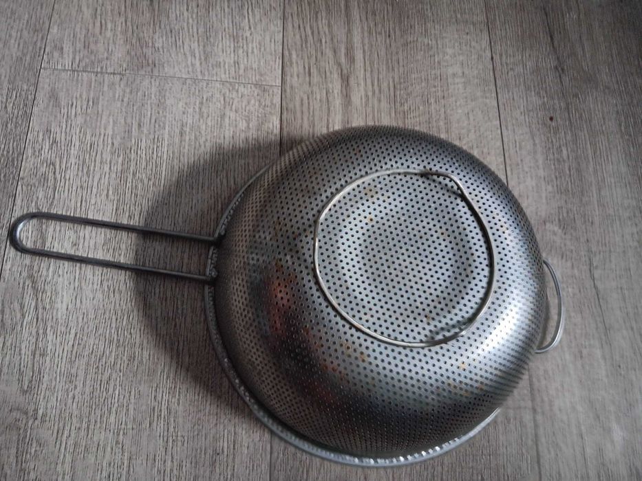 Sitko metalowe o średnicy 25 cm u góry z uchwytem.