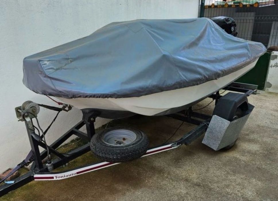 Barco com motor e reboque.