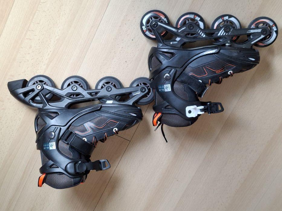 Patins em linha pretos e laranja da Olexo