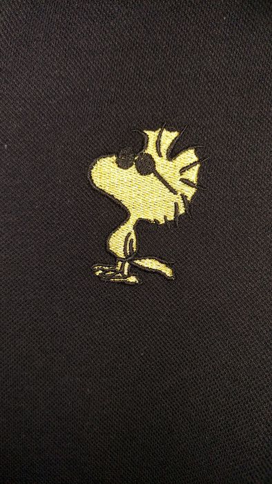 Pólo preto Peanuts 9-10 anos
Novo