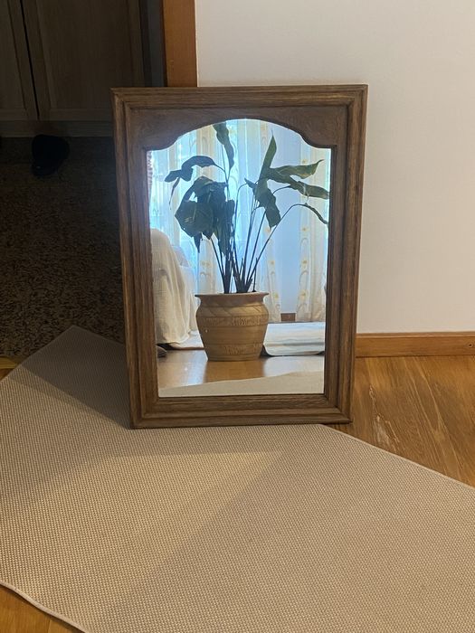 Vintage mirror with painted black wooden frame.
