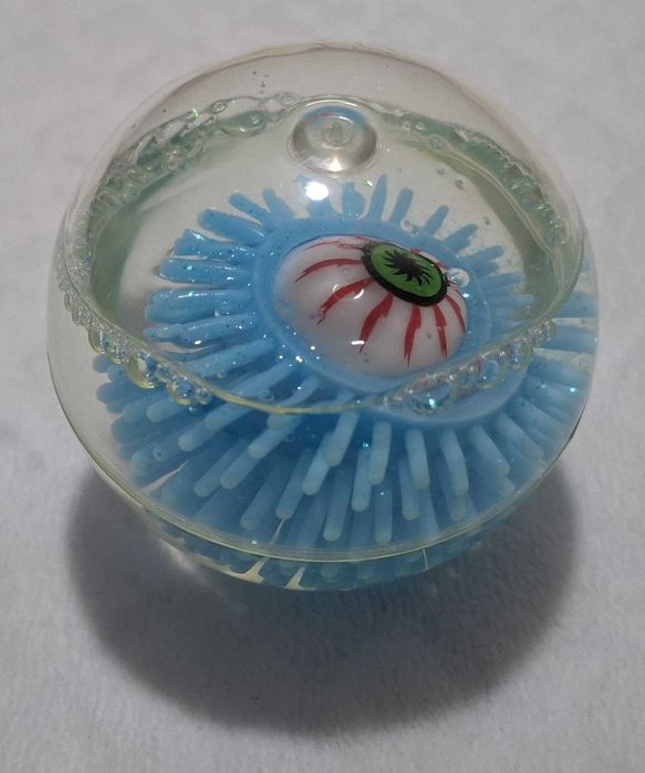 Gumowa kulka z okiem, brokatem, niebieska, 6cm (Zabawka)