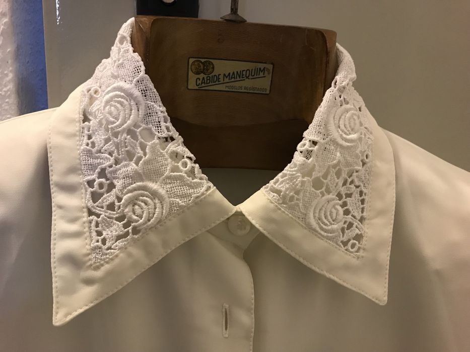 Blusa branca tipo seda com gola trabalhada.