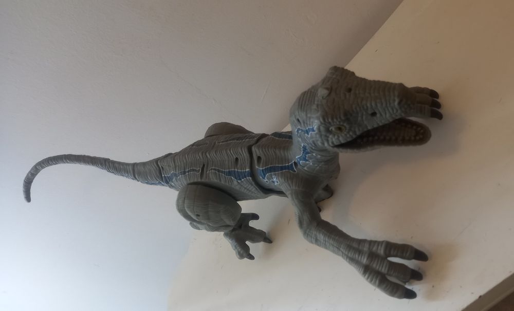 velociraptor dinosaur with sounds and smoke coming out of its mouth.