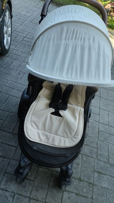 carrinho de bebe preto e beje tem protecao castanha