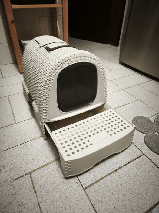 Caixa de arreia fechada com apanhador