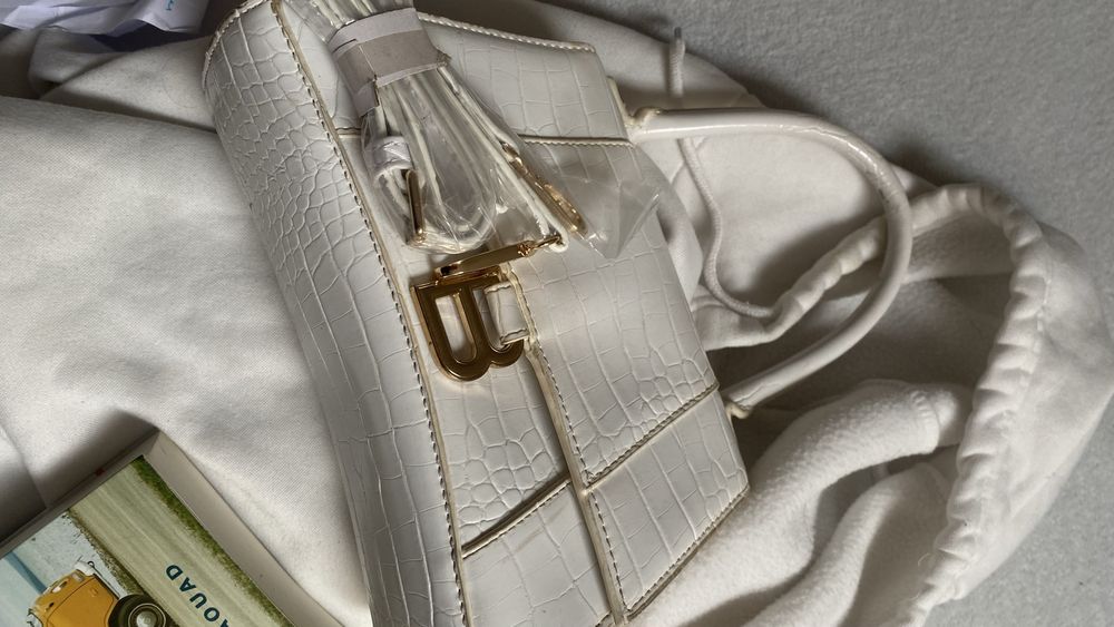 Bolsa branca com simbolo letra B dourado