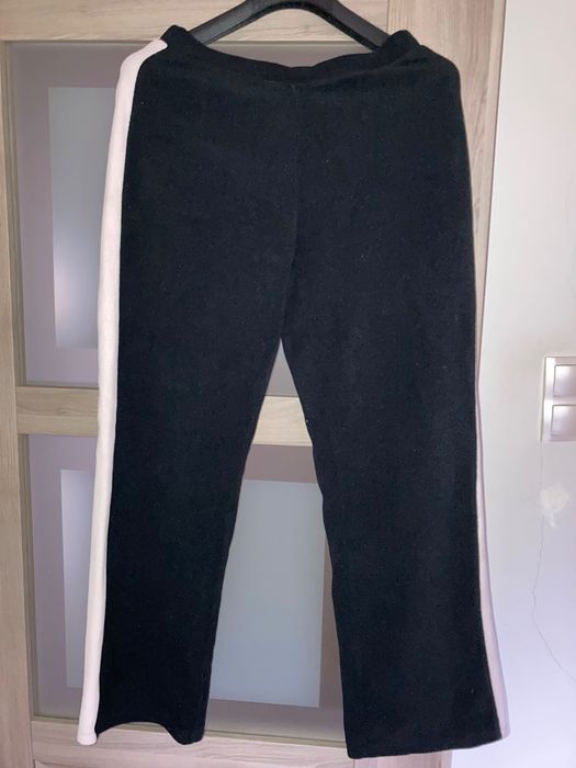 Czarne, damskie polarowe spodnie z lampasem.