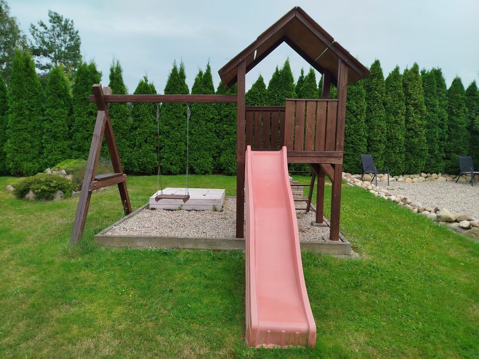 Drewniany domek z huśtawka  Plac zabaw