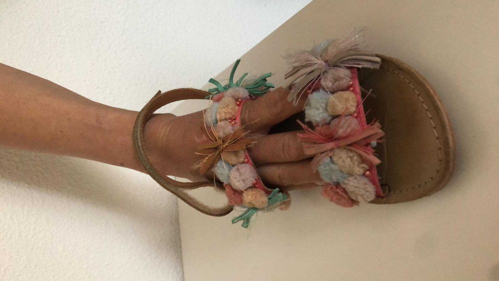 Sandália em pele de menina com pompons