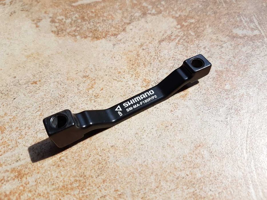 rowerowy ADAPTER hamulca tarczowego Shimano SM-MA-F180P/P2, stan SUPER
