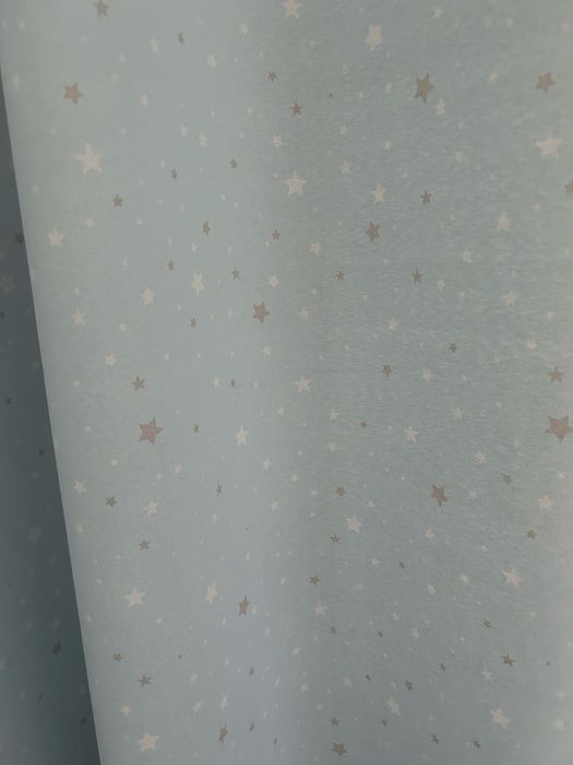 Varão com terminal em estrelas cinza e conjunto de cortinados.