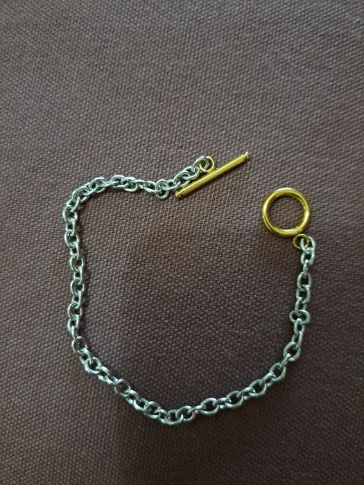 Pulseira em aço prateado e dourado