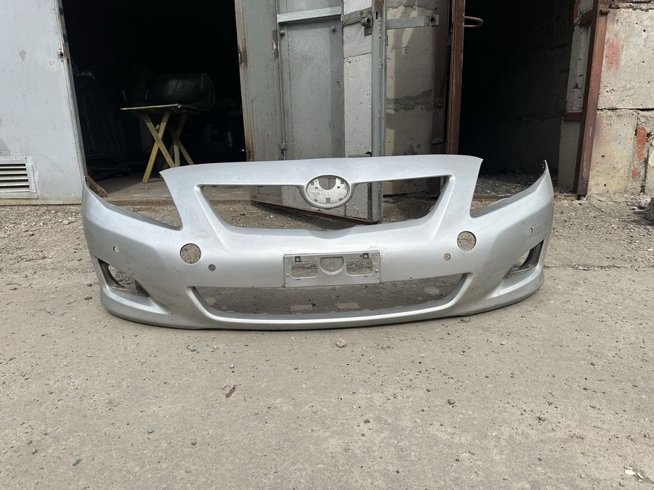 Передний бампер Toyota Corolla (оригинал) 52110-12A60 / 52119-12A70