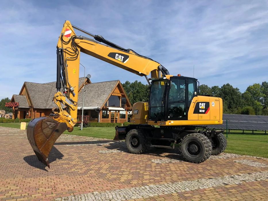 Caterpillar M318F  Transport GRATIS