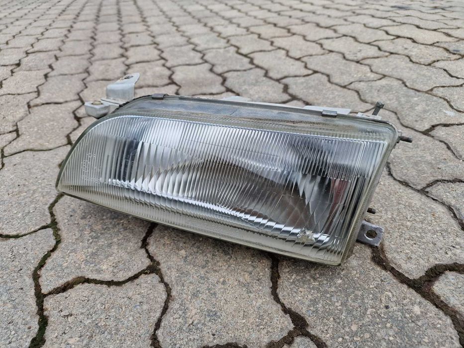 Farol esquerdo Toyota Corolla e100