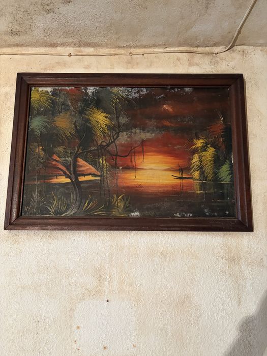 Quadro decorativo com uma pintura de uma paisagem tropical ao pôr do sol, semelhante a obras de arte de ilhas tropicais com palmeiras e barcos
