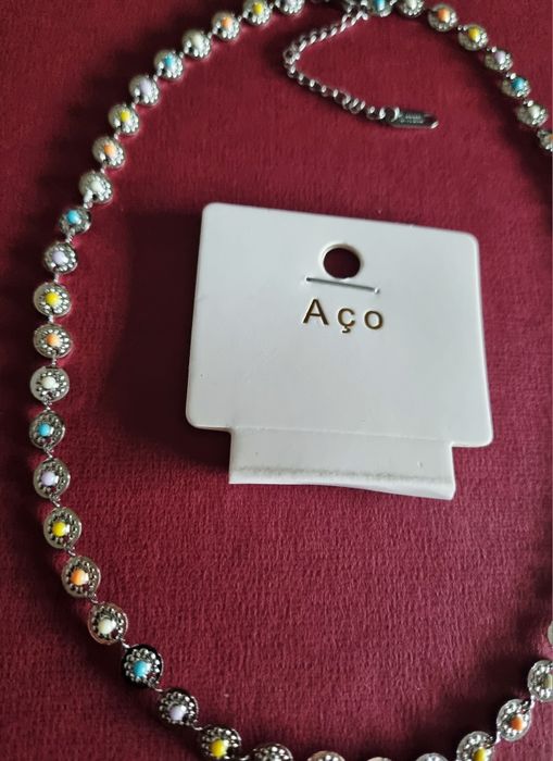 Colar/gargantilha prateado, em aço, com pequenas bolinhas coloridas. T