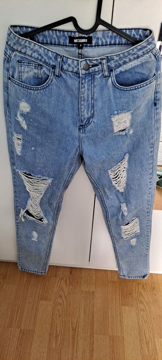 Niebieskie spodnie jeansowe z dziurami Missguided  r.36