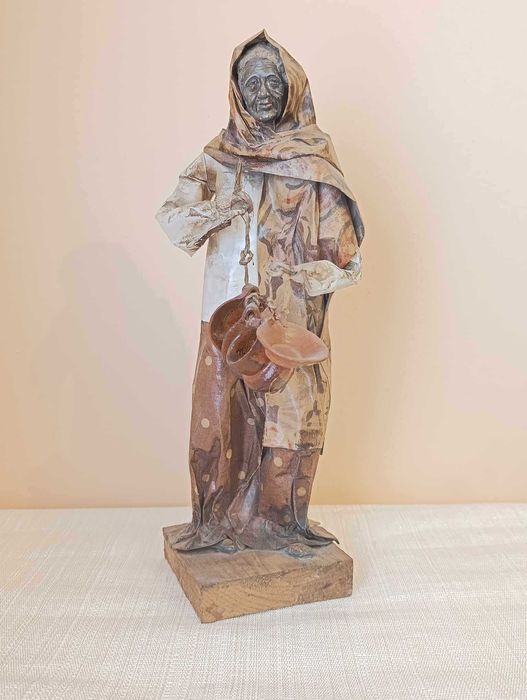 Handcrafted papier-mâché female figure with plates