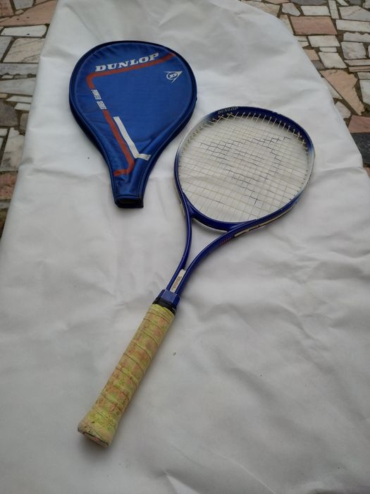 Tennis racket with protective cover.