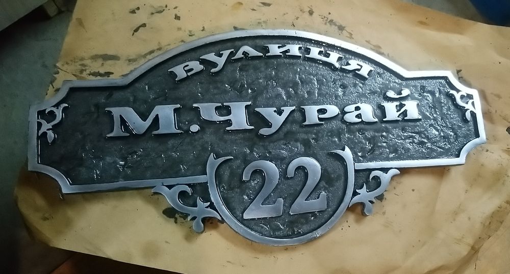 Табличка з адресою на будинок. Адресна табличка вилита з металу.