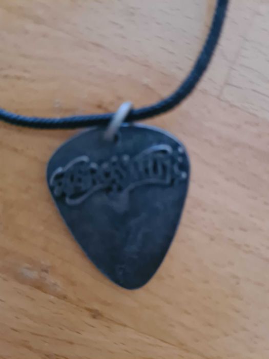 Palheta em Bronze da banda Aerosmith
