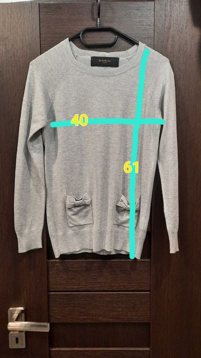 Sweter z kokardkami