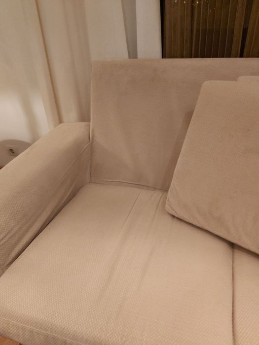 Sofá de 2 lugares com pés de madeira.