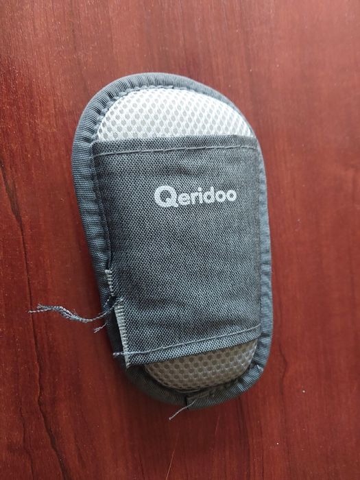 Ochraniacz klamry pasów w przyczepce rowerowej Qeridoo (uszkodzony)