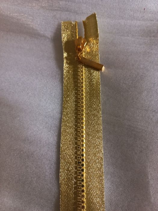 Długi plastikowy suwak złoty nowy