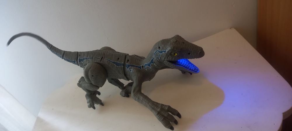 velociraptor dinosaur with sounds and smoke coming out of its mouth.