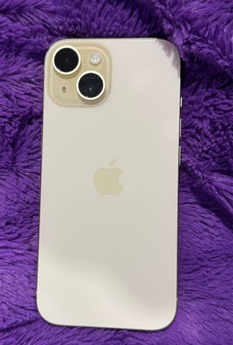 i Phone 15 amarelo na parte de traz, carregador incluido.