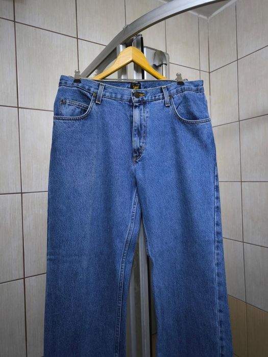 Spodnie męskie L jeansowe marki Lee w kolorze klasycznego, niebieskiego denimu (blue jeans) z widocznym efektem lekkiego marmurkowania. Cholewka o reg