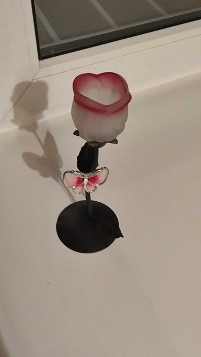 Декоративный металлический подсвечник в форме цветка тюльпана с элементами стекла и бабочкой.