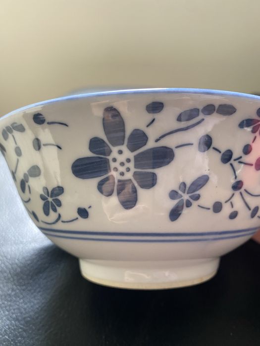 White porcelain cup with blue floral decoration