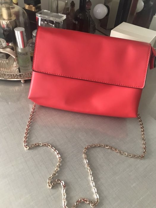 Red bag with golden chain for ceremonies