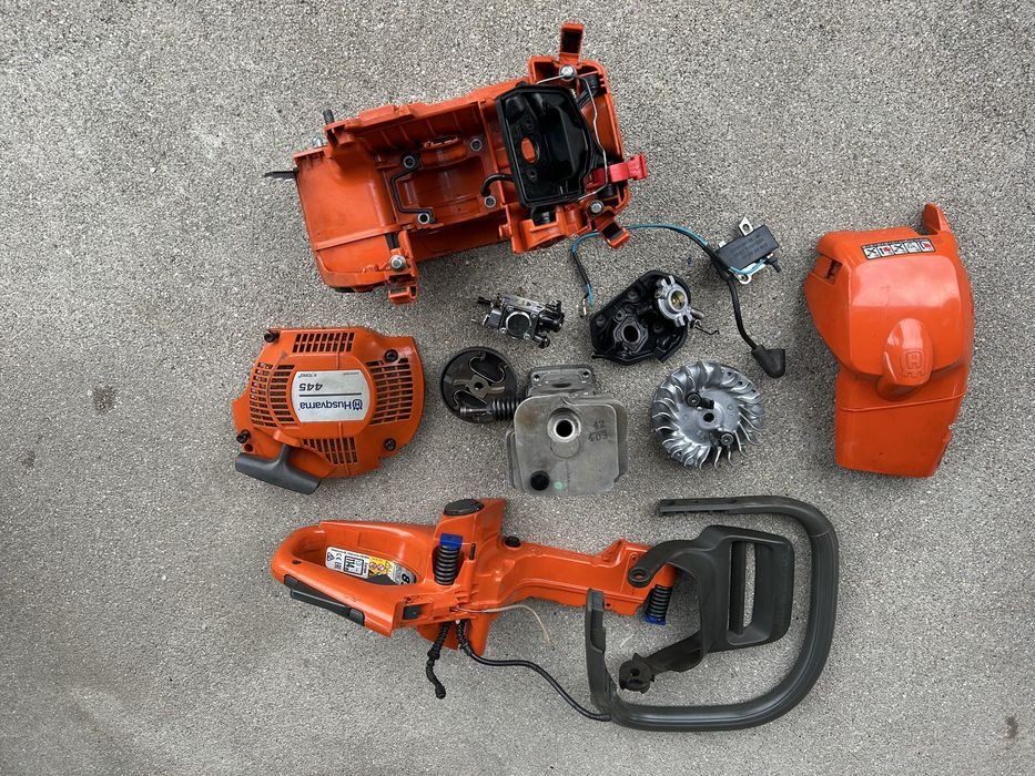Husqvqrna 445 450 szarpak rozrusznik starter cylinder zbiornik gaźnik  korpus obudowa silnikakoło magnetyczne cewka sprzęgło