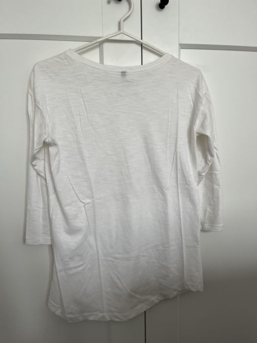 Biała bluzka z rekawem 3/4 i celinami