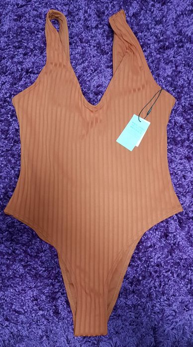 Суцільний, теракотовий купальник в рубчик Primark