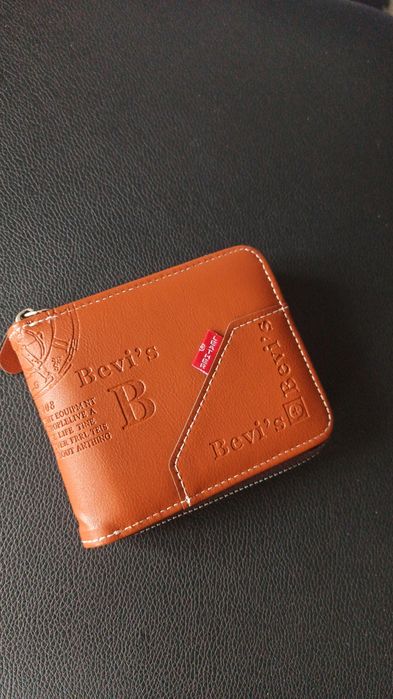 Portfel męski w kolorze brązowym. Nowy, posiada sakiewkę