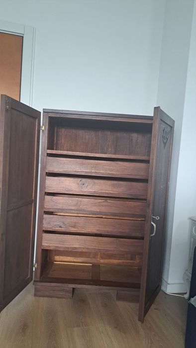 Armário antigo com entalhes florais e prateleiras