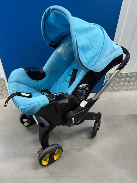 Doona+  Pack Completo: Base Isofix + Mala Oficial + Capa Chuva