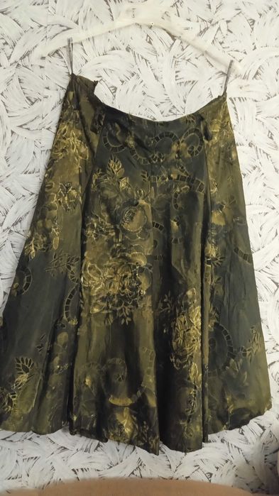 Спідниця з парчової тканини темно зеленого кольору.